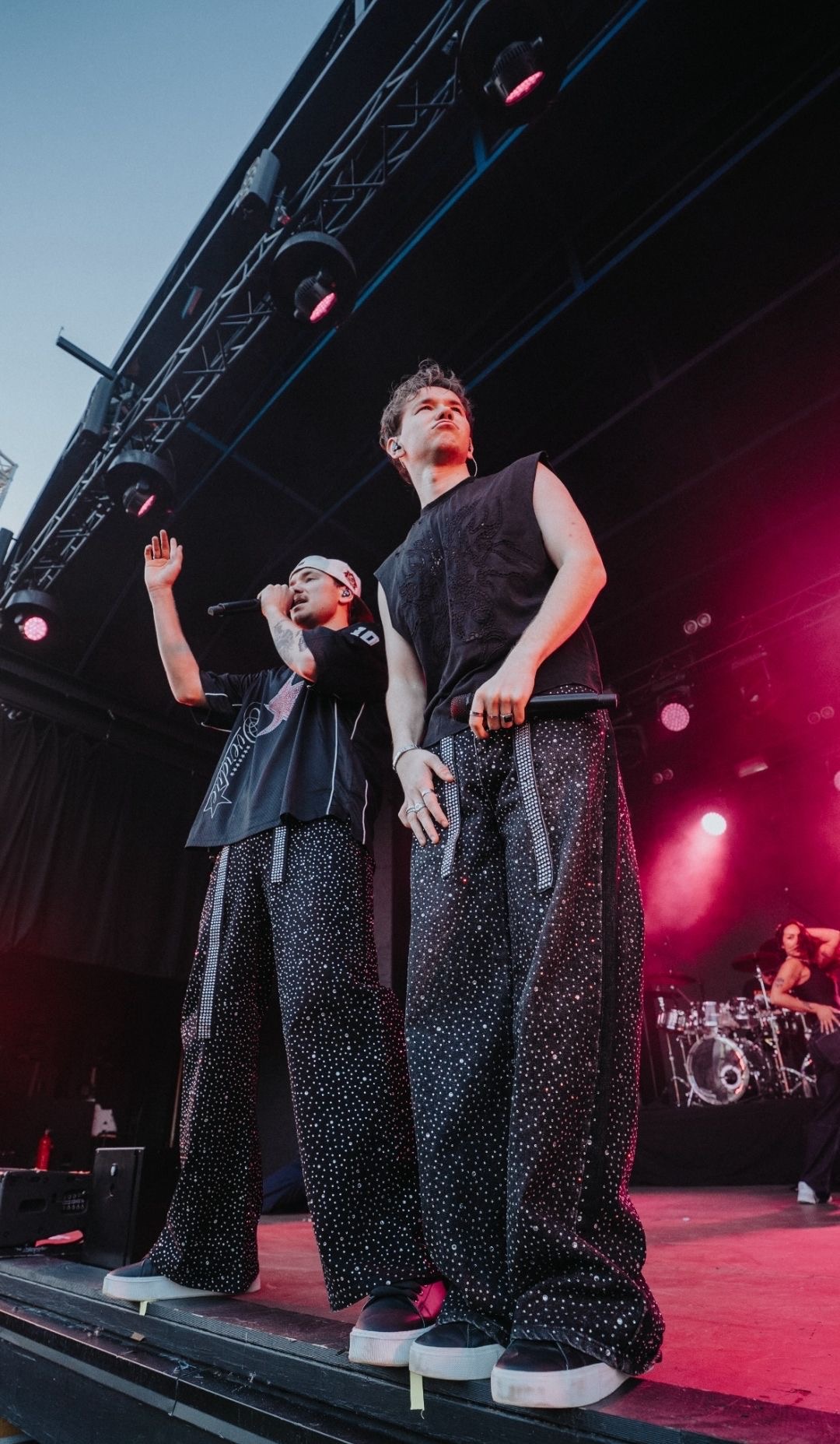 Marcus & Martinus at the front of the stage under pink lights